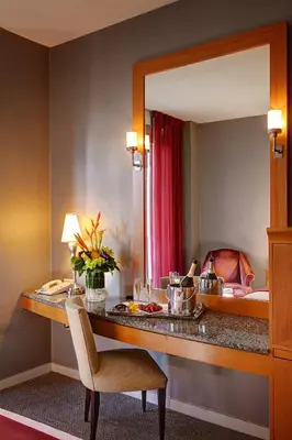 a hotel room with a desk and a mirror at Hotel Giraffe by Library Hotel Collection in New York