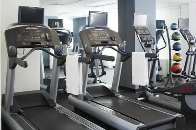a gym with tread machines and a treadmill at The Fifty Sonesta Hotel New York in New York