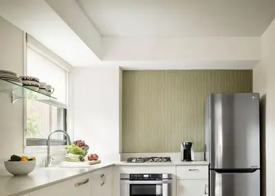a kitchen with a stainless steel refrigerator at The Gardens Sonesta ES Suites New York in New York