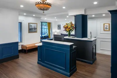 a room with blue cabinets and a counter top at voco The Franklin New York by IHG in New York