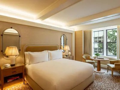a bedroom with a large white bed and a window at The Surrey, A Corinthia Hotel in New York