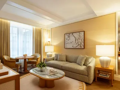 a living room with a couch and a table at The Surrey, A Corinthia Hotel in New York