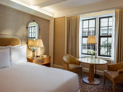 a hotel room with a bed and a table at The Surrey, A Corinthia Hotel in New York