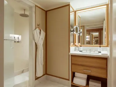 a bathroom with a sink and a mirror at The Surrey, A Corinthia Hotel in New York