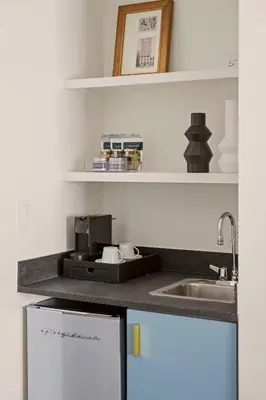 a kitchen with a sink and a counter top at Newly Renovated Rooms at Club Quarters Hotel Times Square, New York in New York