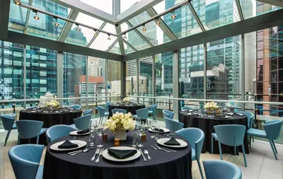 a conference room with tables and chairs and windows at The Time New York, part of JdV by Hyatt in New York