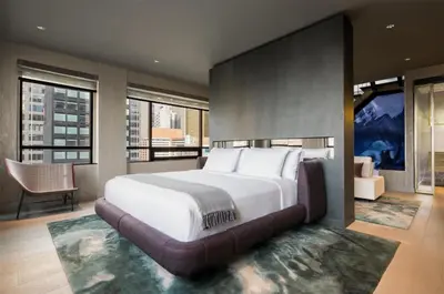 a large bedroom with a large bed and windows at The Time New York, part of JdV by Hyatt in New York