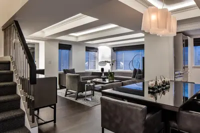 a living room with a couch and a table at AKA Sutton Place in New York