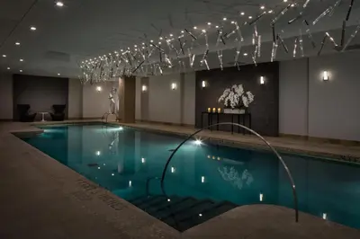 a pool in a hotel with lights above it at AKA Sutton Place in New York