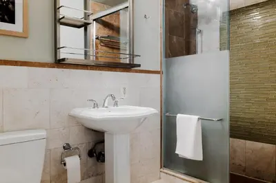 a bathroom with a sink and a shower at The Bayard in New York