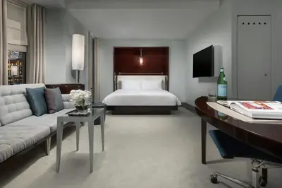 a living room with a bed and a couch at Royalton New York in New York