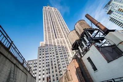 a tall building in the background with a factory at The Hotel at Fifth Avenue in New York