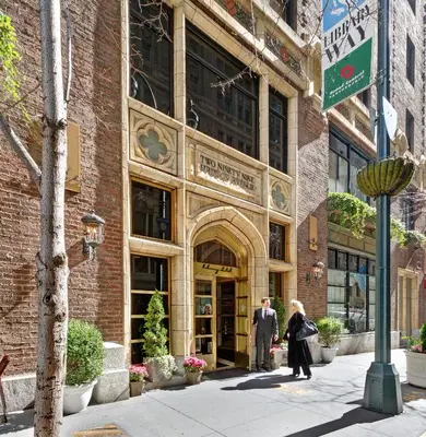 a couple of people standing outside of a building at Library Hotel by Library Hotel Collection in New York