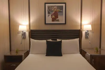 a bedroom with a large bed with two night stands at Iroquois New York Times Square in New York