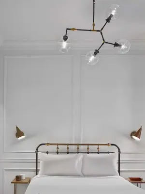 a bedroom with a white bed with two lights above it at Life Hotel New York in New York