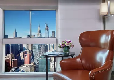 a room with a chair and a window with a view at Millennium Hilton New York One UN Plaza in New York