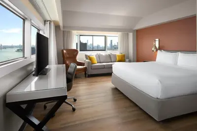 a hotel room with a bed and a desk at Millennium Hilton New York One UN Plaza in New York