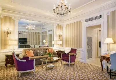 a living room with a couch and chairs and a chandelier at 5th & 55th Residence Club in New York