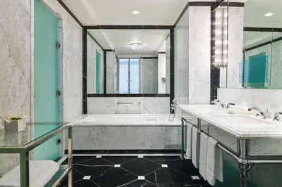 a bathroom with two sinks and a tub at 5th & 55th Residence Club in New York
