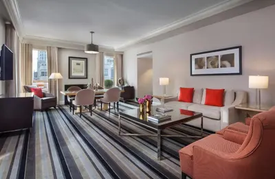 a living room with a couch and a table at Omni Berkshire Place in New York