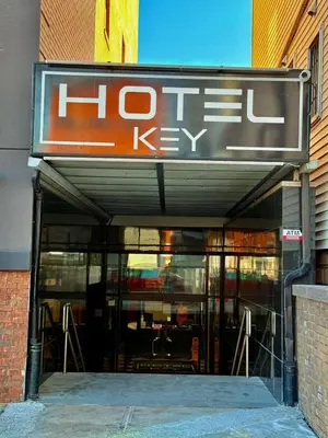 a store front with a sign for a hot key at Hotel Key in Queens