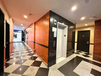 a hallway with black and white checkered floor at Hotel Key in Queens