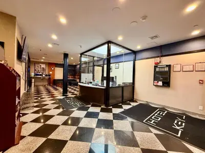 a lobby with a checkered floor in a building at Hotel Key in Queens