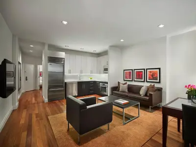 a living room with a couch and a table at AKA Times Square in New York