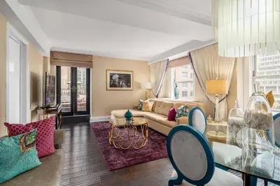 a living room with a couch and a glass table at The Lexington Hotel, Autograph Collection in New York