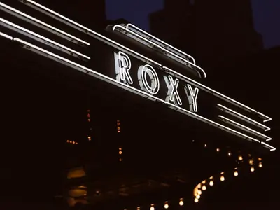 a neon sign for a roxary restaurant on a building at Roxy Hotel New York in New York