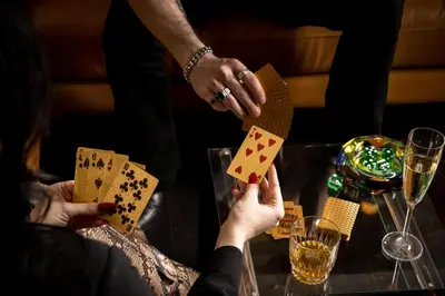a couple playing poker at a table with glasses of champagne at Roxy Hotel New York in New York