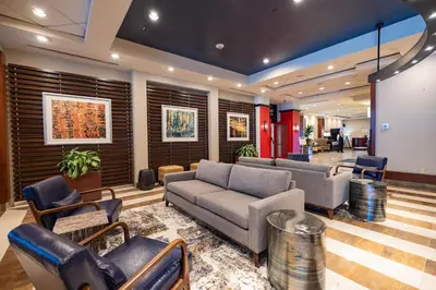 a lobby with couches and chairs in a building at Sheraton Lincoln Harbor Hotel in Weehawken