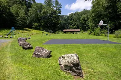 a park with rocks in the grass with a basketball hoop at Candlewood Suites Windsor Locks by IHG in Windsor Locks