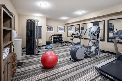 a fitness room with treadmills and exercise equipment at Candlewood Suites Windsor Locks by IHG in Windsor Locks