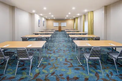a classroom with rows of tables and chairs at Candlewood Suites Windsor Locks by IHG in Windsor Locks