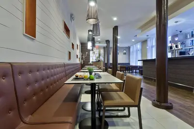 a dining room with a table and chairs at Eurostars Wall Street in New York