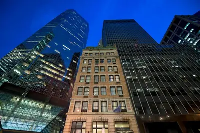 two tall buildings in a city at night at Eurostars Wall Street in New York
