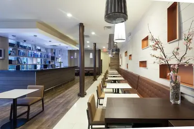 a row of tables and chairs in a restaurant at Eurostars Wall Street in New York