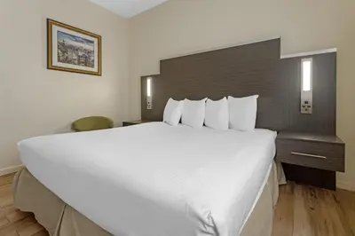 a large white bed in a hotel room at Best Western Jamaica Inn in Queens