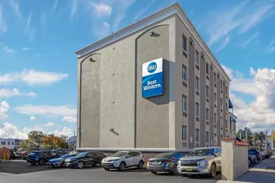 a building with a sign on the side of it at Best Western Jamaica Inn in Queens