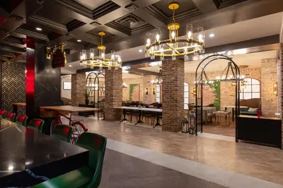 a restaurant with chairs and tables and chandeliers at Westgate New York Grand Central in New York