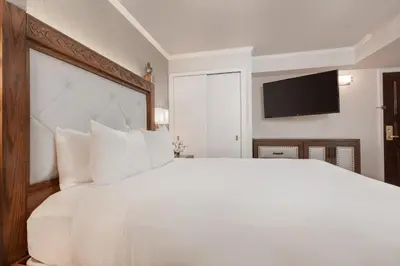 a bedroom with a large white bed and a flat screen tv at Westgate New York Grand Central in New York
