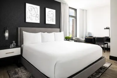 a bedroom with a white bed and a desk at Arthouse Hotel in New York