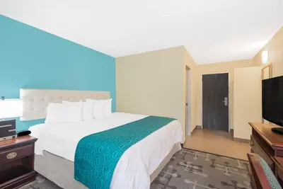 a hotel room with a bed and a flat screen tv at Howard Johnson by Wyndham Saugerties in Saugerties