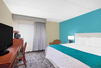 a hotel room with a large bed and a desk at Howard Johnson by Wyndham Saugerties in Saugerties