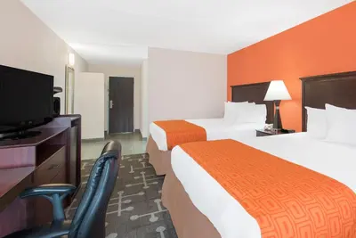 a hotel room with two beds and a flat screen tv at Howard Johnson by Wyndham Saugerties in Saugerties