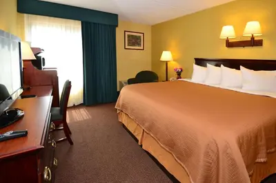 a hotel room with a bed and a television at Howard Johnson by Wyndham Saugerties in Saugerties
