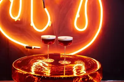 two glasses of wine sitting on top of a table at Paramount Times Square - A Generator Hotel in New York