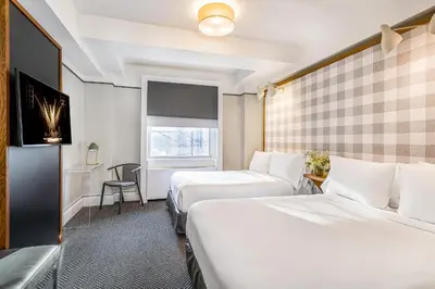 a hotel room with two beds and a window at Paramount Times Square - A Generator Hotel in New York