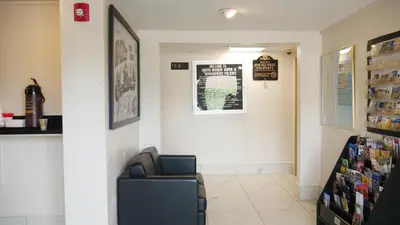 a waiting room with a chair and a window at Super 8 by Wyndham North Bergen NJ/NYC Area in North Bergen